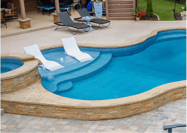 inground swimming pool with tanning ledge and spa