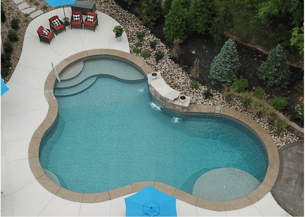 inground swimming pool with tanning ledge and spa