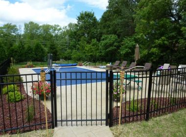 inground pool behind fence