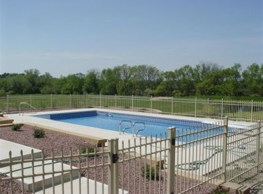 inground pool behind fence