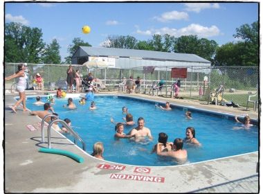 people playing in inground pool