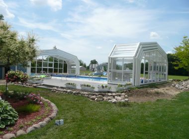 inground pool with glass enclosures on either end